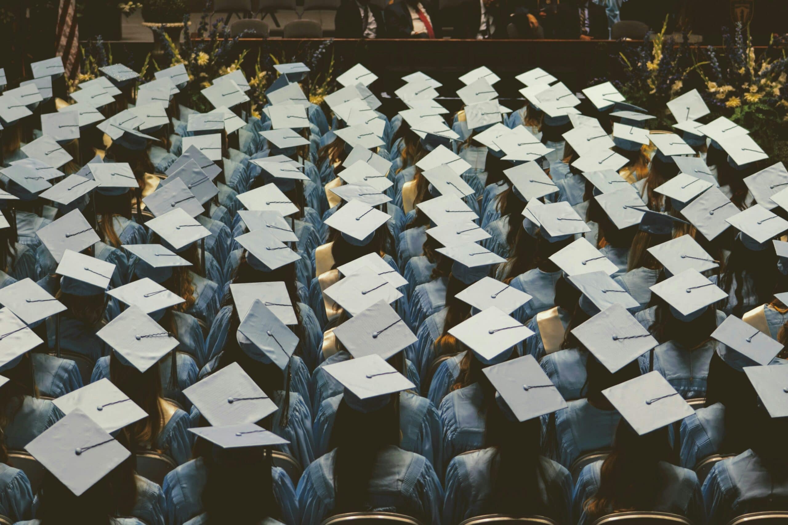 graduate students in blue academic hats